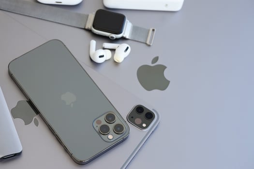 KYIV, UKRAINE - 4 MAY, 2023 Apple brand devices iphone, ipad and airpods with apple watch lies on macbook body photo