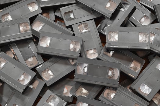 KYIV, UKRAINE - 4 MAY, 2023 tape on colored background, VHS, cassette. Messy stack of VHS tapes. Home System tape photo