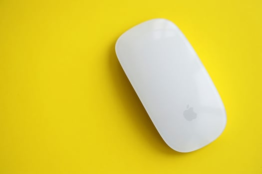 KYIV, UKRAINE - NOVEMBER 27, 2023 Apple Magic Mouse 3rd generation lies on bright colored background photo