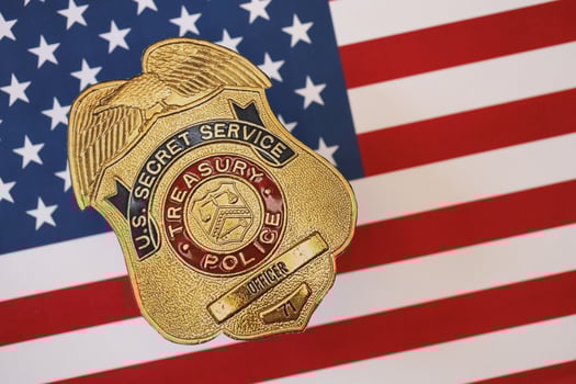 KYIV, UKRAINE - MARCH 9, 2024 US Treasury Police Secret Service Officer badge on United States of America flag photo