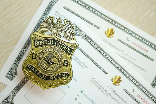 KYIV, UKRAINE - MARCH 9, 2024 US Border Patrol Agent badge on certificate of naturalization photo