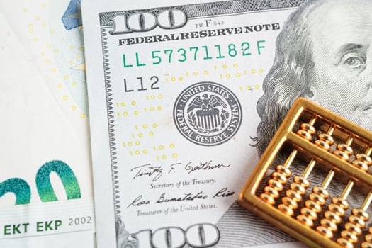 Gold abacus on banknote money, finance trading investment business currency concept. photo
