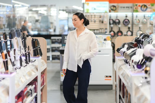 Beautiful woman in the store is testing a hairdryer photo
