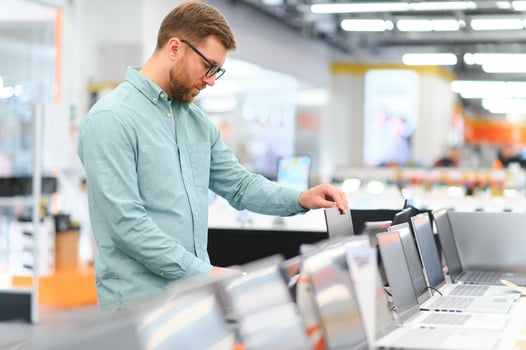 Man buying laptop at electronic store photo