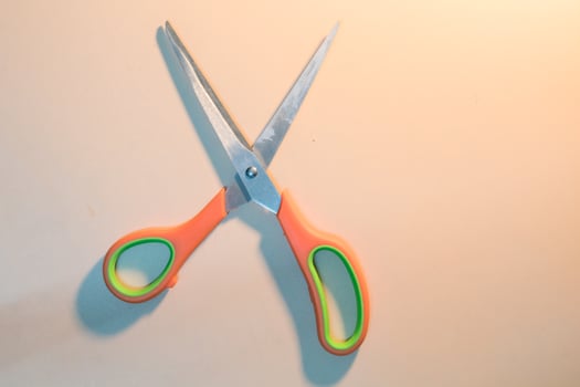 Stainless steel scissor with orange handle photo