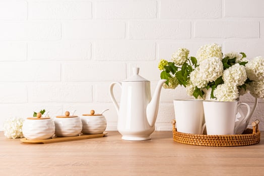 coffee pot, a set of jars of sugar, coffee, cinnamon on a wooden countertop. a bouquet of flowering branches in a jug. Still life kitchen. photo