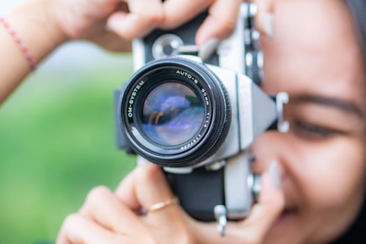 Person taking a photo with a vintage camera