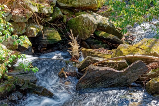 Fast flowing creek around the boulders photo
