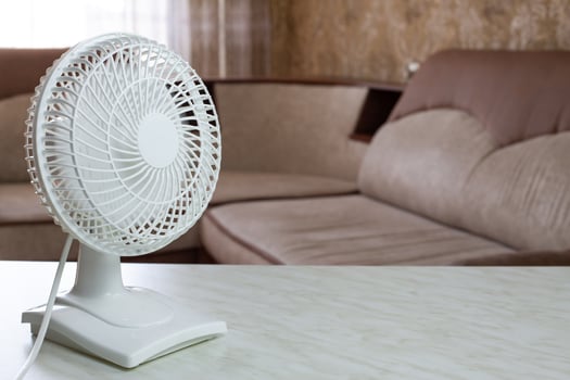 Tabletop white fan disperses cold air throughout the home room photo