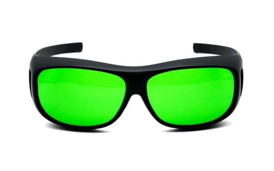 Cool black sports sunglasses with green lenses or night vision glasses are glasses that are centered out on white isolated background. photo