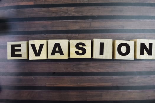 Concept of The wooden Cubes with the word Evasion on wooden background. photo