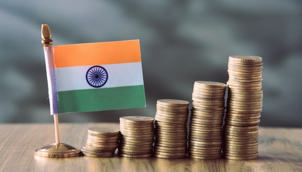 Stacked coins symbolizing financial growth, with India Flag photo