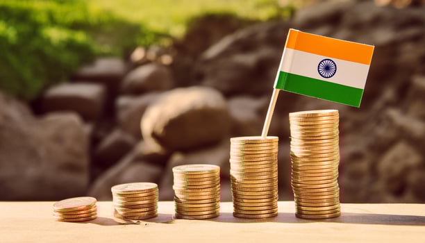 Stacked coins symbolizing financial growth, with India Flag photo