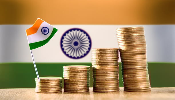 Stacked coins symbolizing financial growth, with India Flag photo