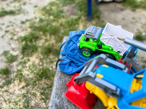 Colourful Sand toys tractor and car for children in the sandbox photo