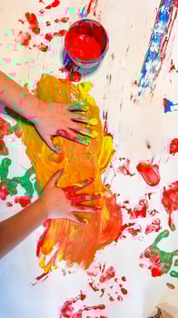Child's hand painted watercolor in heart shape against white background photo