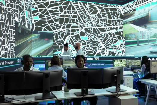 African american call center employee communicates satellite map routes to help couriers deliver orders in time. Operator works on express shipping service, CCTV surveillance navigation. photo