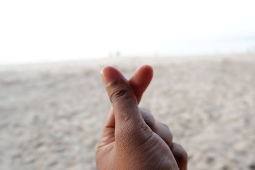 a person making a peace sign with their hand photo