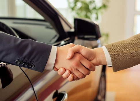 Close up of handshake in the car dealership offices photo