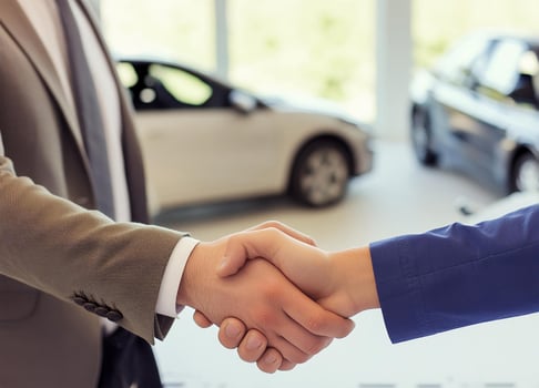 Close up of handshake in the car dealership offices photo