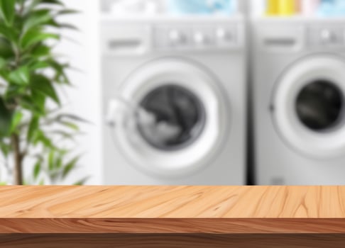 Wood table for display products on blurred laundry room photo