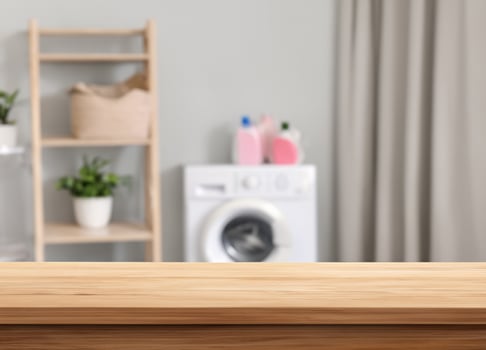 Wood table for display products on blurred laundry room photo