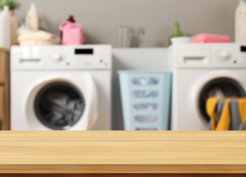 Wood table for display products on blurred laundry room photo