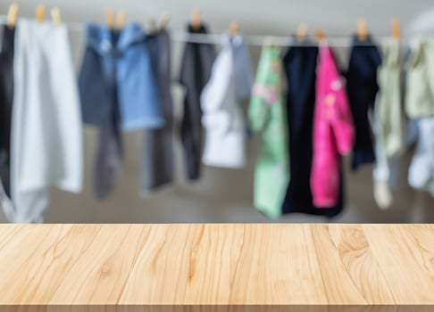 Wooden display table with blurred children's clothes photo