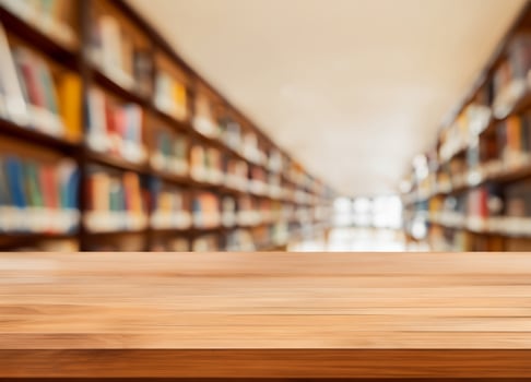 Empty wooden table and blurred modern library photo
