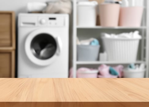 Wood table for display products on blurred laundry room photo