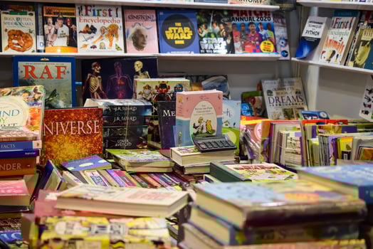 New Delhi, India, February 17 2024 - Variety of Books on shelf inside a book-stall at Delhi International Book Fair, Selection of books on display in Annual Book Fair at Bharat Mandapam complex photo