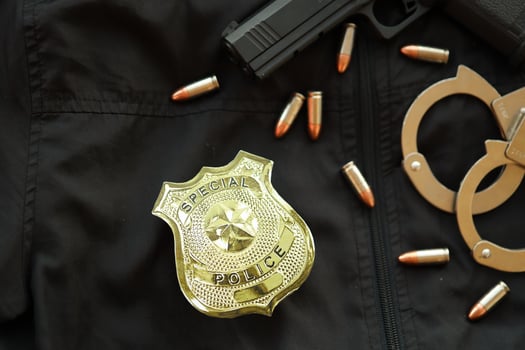 KYIV, UKRAINE - MARCH 9, 2024 US Special Police badge on black jacket uniform with gun, bullets and handcuffs photo