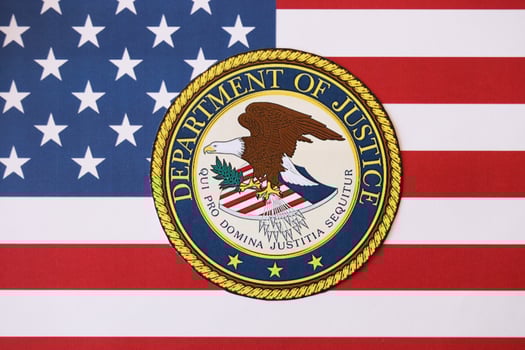 KYIV, UKRAINE - MARCH 9, 2024 US Department of Justice seal on United States of America flag photo