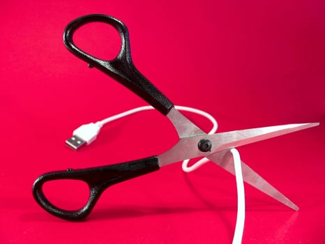 cutting wire with scissors - tech, internet, information and communication styled concept photo
