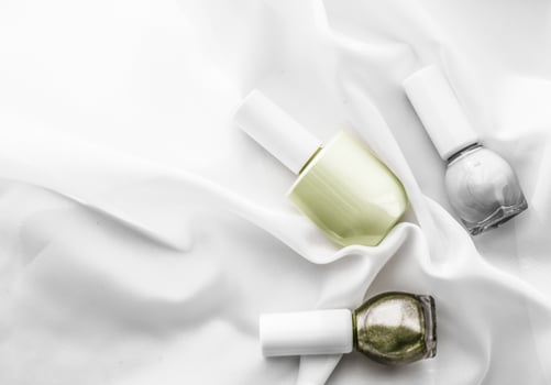 Nail polish bottles on silk background, french manicure products and nailpolish make-up cosmetics for luxury beauty brand and holiday flatlay art design photo
