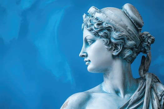 Female antique aged Statue woman head isolated on a blue background with copy space photo