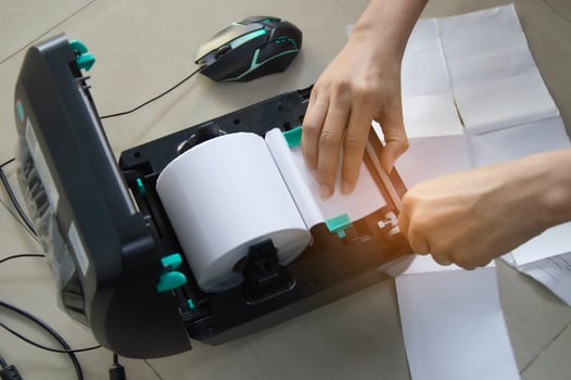 Top view. Technician repairing printer, label printer. photo