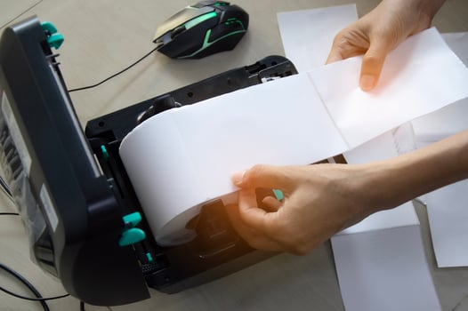 Top view. Technician repairing printer, label printer. photo