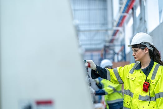 Male and female engineers in neat work clothes prepare and control the production system of large modern machines in a factory producing industrial technology products. photo