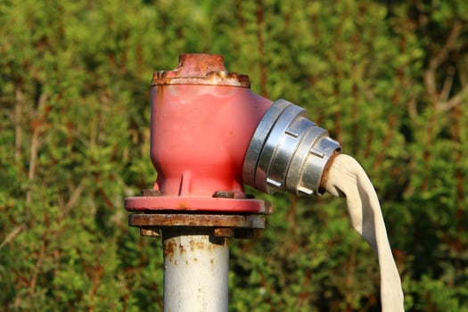 Water tap and pipes for pumping water to the pumping station. photo