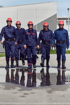 A team of confident and accomplished firefighters strides purposefully in their uniforms, exuding pride and satisfaction after successfully completing a challenging firefighting mission photo