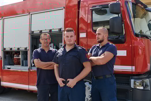 A skilled and dedicated professional firefighting team proudly poses in front of their state of the art firetruck, showcasing their modern equipment and commitment to ensuring public safety. photo