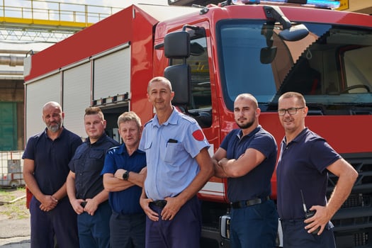 A skilled and dedicated professional firefighting team proudly poses in front of their state of the art firetruck, showcasing their modern equipment and commitment to ensuring public safety. photo