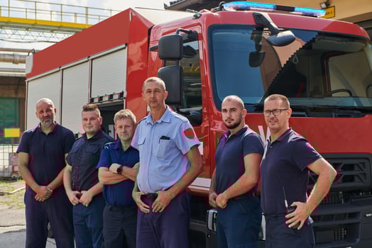 A skilled and dedicated professional firefighting team proudly poses in front of their state of the art firetruck, showcasing their modern equipment and commitment to ensuring public safety. photo