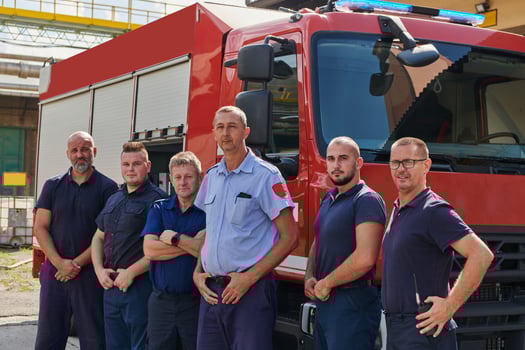 A skilled and dedicated professional firefighting team proudly poses in front of their state of the art firetruck, showcasing their modern equipment and commitment to ensuring public safety. photo