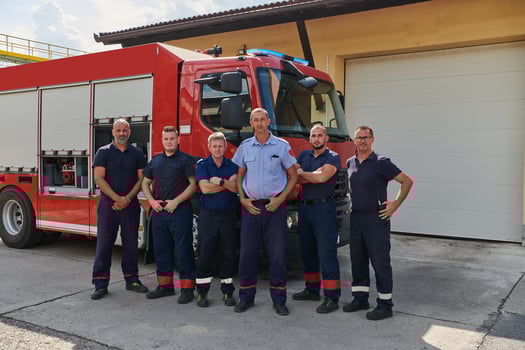 A skilled and dedicated professional firefighting team proudly poses in front of their state of the art firetruck, showcasing their modern equipment and commitment to ensuring public safety. photo