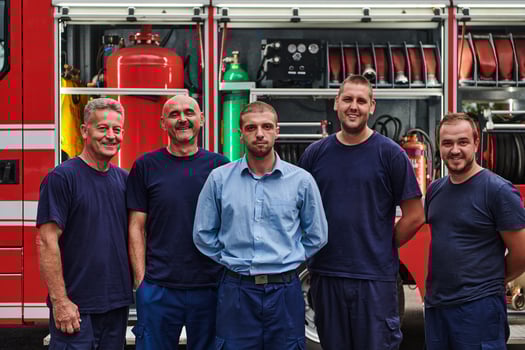 A skilled and dedicated professional firefighting team proudly poses in front of their state of the art firetruck, showcasing their modern equipment and commitment to ensuring public safety. photo