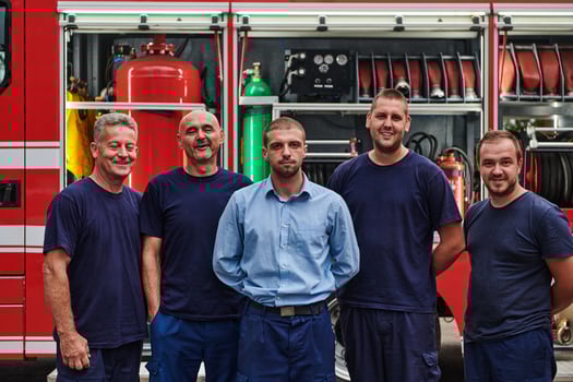 A skilled and dedicated professional firefighting team proudly poses in front of their state of the art firetruck, showcasing their modern equipment and commitment to ensuring public safety. photo