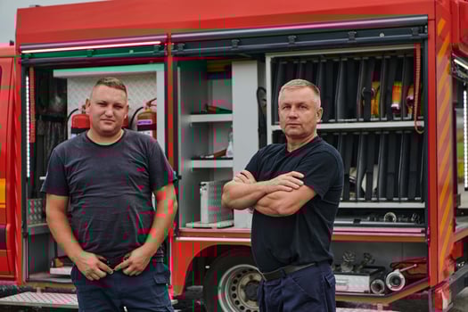 A skilled and dedicated professional firefighting team proudly poses in front of their state of the art firetruck, showcasing their modern equipment and commitment to ensuring public safety. photo