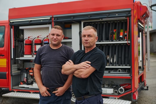 A skilled and dedicated professional firefighting team proudly poses in front of their state of the art firetruck, showcasing their modern equipment and commitment to ensuring public safety. photo